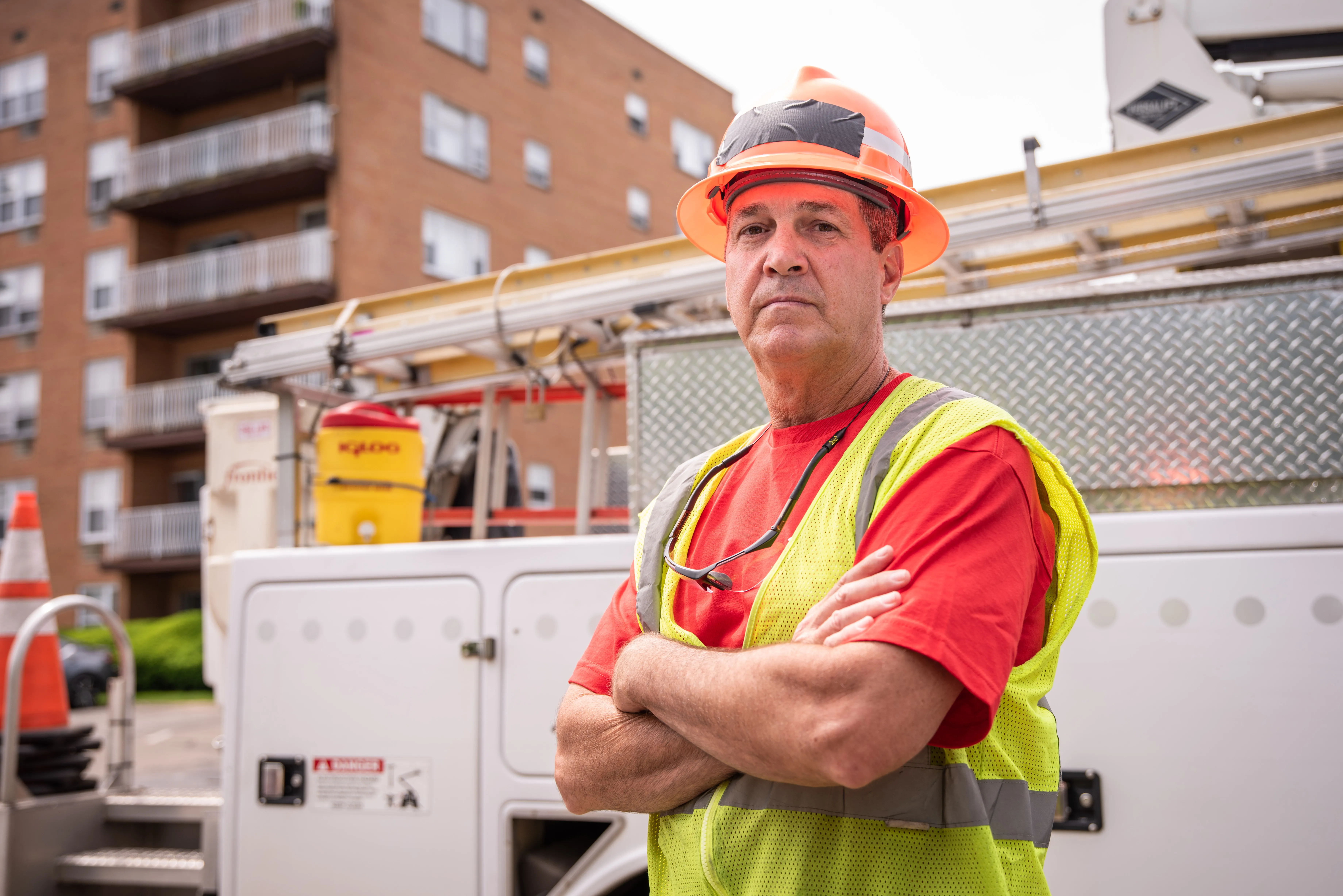 CWA Local 1298 Frontier worker with hard hat standing in front of building