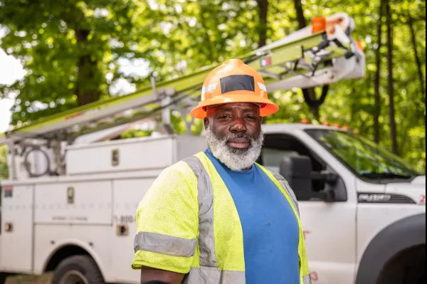 CWA Local 1298 Frontier worker with hard hat standing in front of truck